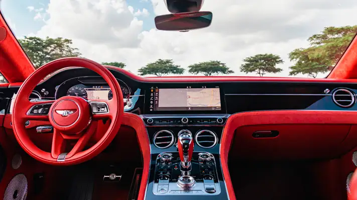 White on red Bentley GT rental Miami dashboard view mph club