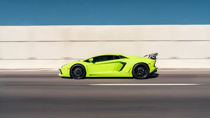 Green Lamborghini Aventador rental side view mph club