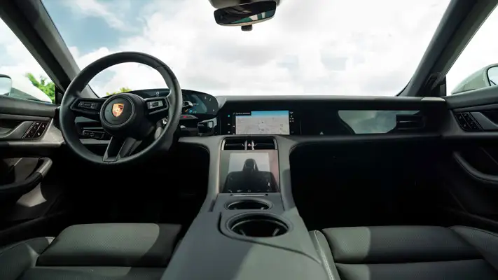 Grey on black Porsche Taycan rental Miami dashboard view mph club