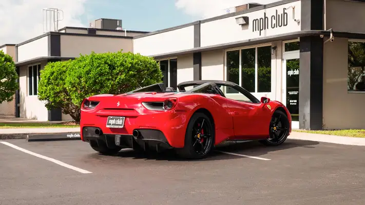 Red on black Ferrari 488 Spider for rent miami rear view mph club