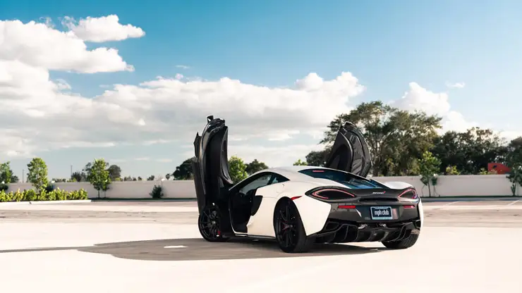 White McLaren 570s rental rear view mph club