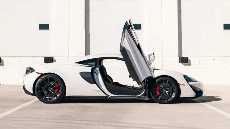 White McLaren 570s rental side view mph club