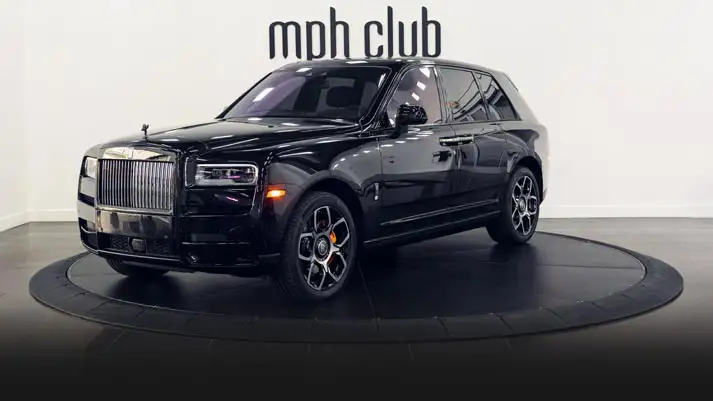 Black on orange 4 seater Rolls Royce Cullinan Black Badge rental profile view turntable rszd mph club