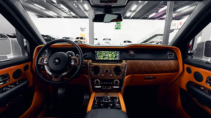 White exterior with orange interior Rolls Royce Cullinan rental dashboard view mph club