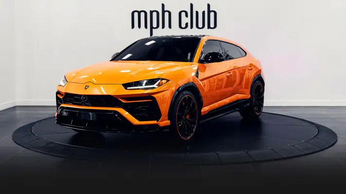 Orange Lamborghini Urus SUV rental profile view rszd - mph club