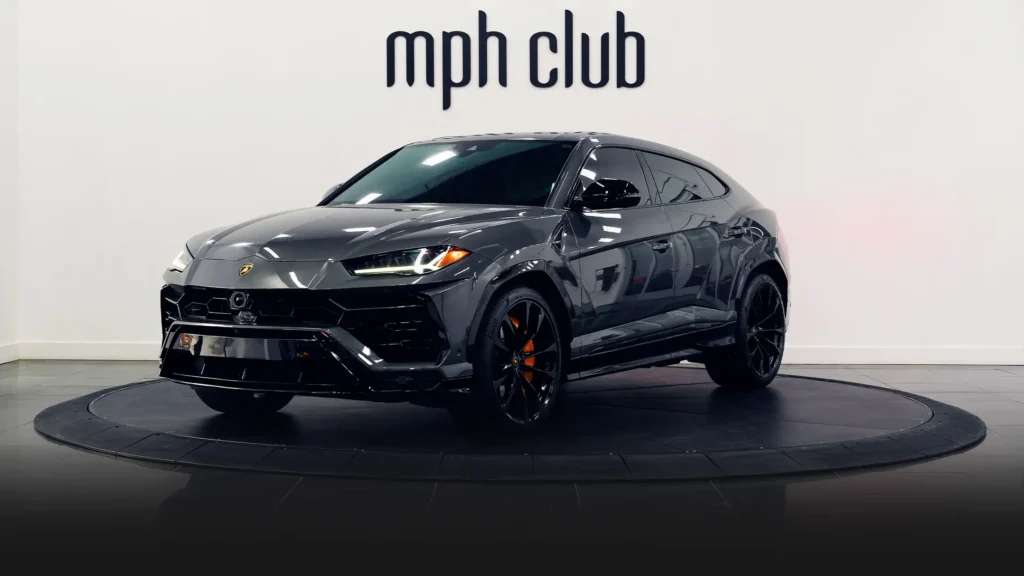 Grey on orange Lamborghini Urus for rent Miami profile view - mph club