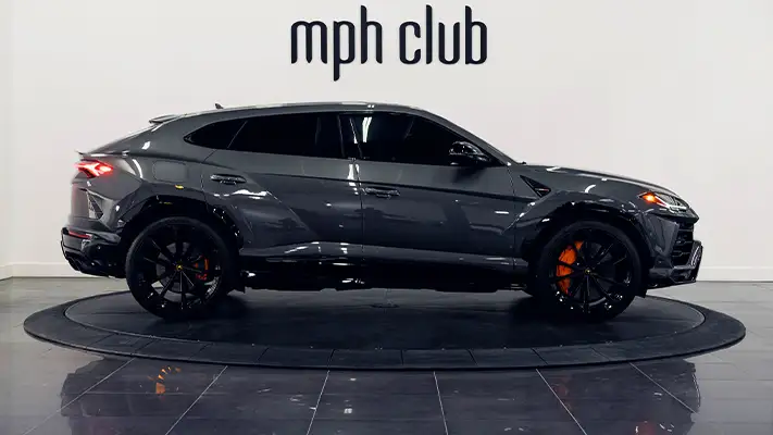 Grey on orange Lamborghini Urus for rent Miami side view - mph club